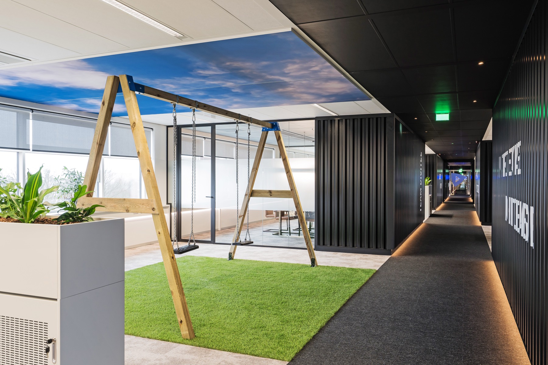 Divitel Apeldoorn office — indoor swing and green workspace